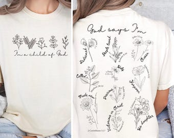 Könnte beinhalten: Cremefarbenes T-Shirt mit schwarzen floralen Linienzeichnungen und dem Text "I'm a child of God" auf der Vorderseite. Die Rückseite zeigt weitere florale Designs und die Worte "God says I'm" mit Schriftstellen.