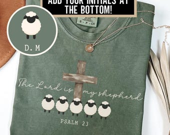May include: Green t-shirt with the text "The Lord is my shepherd" and a cross graphic. Below the text are five sheep illustrations. The shirt also features the text "Psalm 23" and "ADD YOUR INITIALS AT THE BOTTOM!"