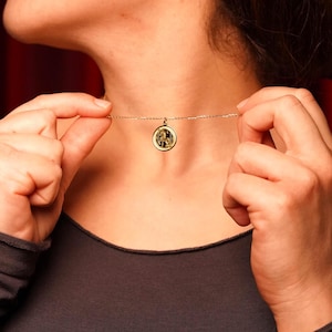 14k solid gold model close-up featuring the Year of the Horse necklace centered at the collarbone for a minimal everyday look. The round coin pendant represents Horse energy in Chinese astrology—freedom, passion, and forward progress—making it meaningful for zodiac birthdays and New Year celebrations. SEO terms: Chinese zodiac necklace, horse pendant, astrology jewelry, lunar new year gift, gold medallion charm, delicate layering necklace.