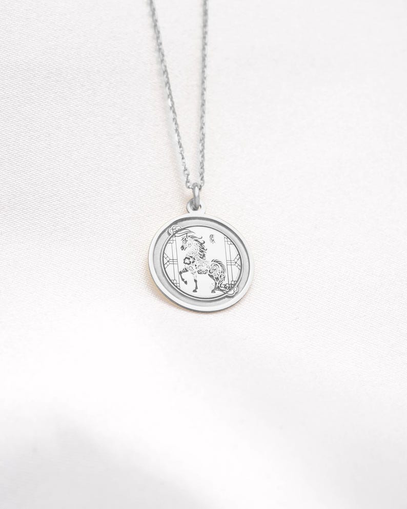 14k white gold Year of the Horse necklace photographed on a clean background, showing the cool-toned metal finish and the engraved Chinese zodiac horse motif on a round medallion. The Horse symbolizes freedom, energy, and forward movement, making it perfect for Lunar New Year or zodiac birthday gifting. SEO: white gold horse necklace, chinese zodiac pendant, zodiac necklace, astrology jewelry, medallion charm, handcrafted engraving-ready necklace for keepsakes.