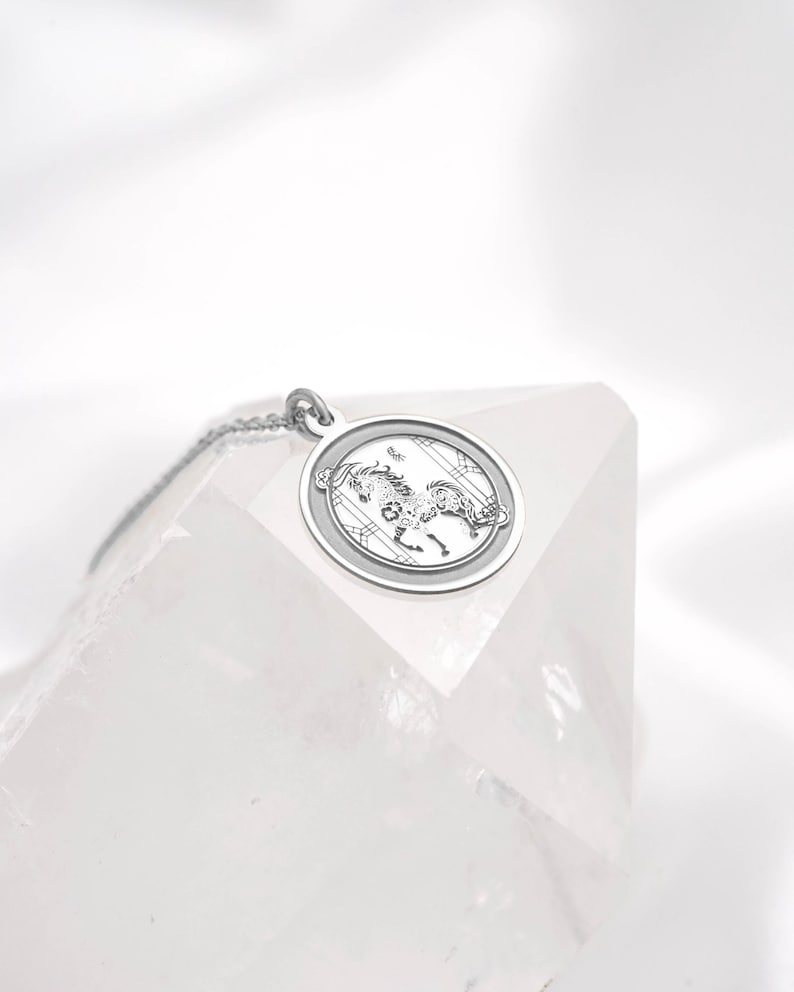 Flatlay of the 14k white gold Year of the Horse coin pendant necklace, showing the round medallion silhouette and smooth reflective surface. In Chinese zodiac tradition, the Horse represents independence, vitality, and brave new beginnings—ideal for meaningful gifting. SEO keywords: white gold zodiac necklace, horse pendant necklace, chinese zodiac jewelry, lunar new year gift, astrology necklace, minimalist medallion charm, free engraving keepsake.