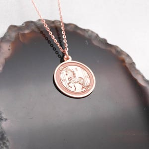 Back view and edge profile of the 14k solid gold Year of the Horse pendant necklace, highlighting the smooth surface for personalization and the clean circular silhouette. This Chinese zodiac medallion symbolizes bold forward motion and independence, making it a personal everyday talisman. SEO keywords: free engraving necklace, horse zodiac charm, lunar new year gift, chinese zodiac pendant, solid gold coin necklace, handmade fine jewelry.