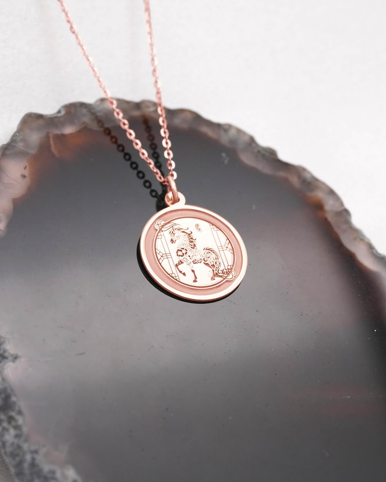 Back view and edge profile of the 14k solid gold Year of the Horse pendant necklace, highlighting the smooth surface for personalization and the clean circular silhouette. This Chinese zodiac medallion symbolizes bold forward motion and independence, making it a personal everyday talisman. SEO keywords: free engraving necklace, horse zodiac charm, lunar new year gift, chinese zodiac pendant, solid gold coin necklace, handmade fine jewelry.