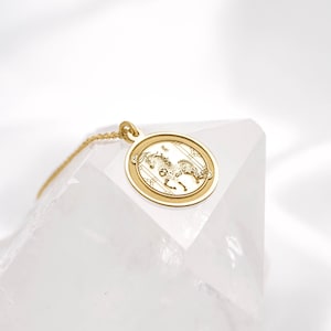 Minimalist 14k solid gold Year of the Horse pendant necklace photographed on clean white textile, highlighting the engraved horse design inside a smooth circular frame. A symbolic Chinese zodiac charm representing freedom and unstoppable drive, perfect for everyday layering. SEO terms: horse necklace, zodiac necklace, Chinese astrology jewelry, lunar new year gift, gold coin pendant, handmade medallion necklace.