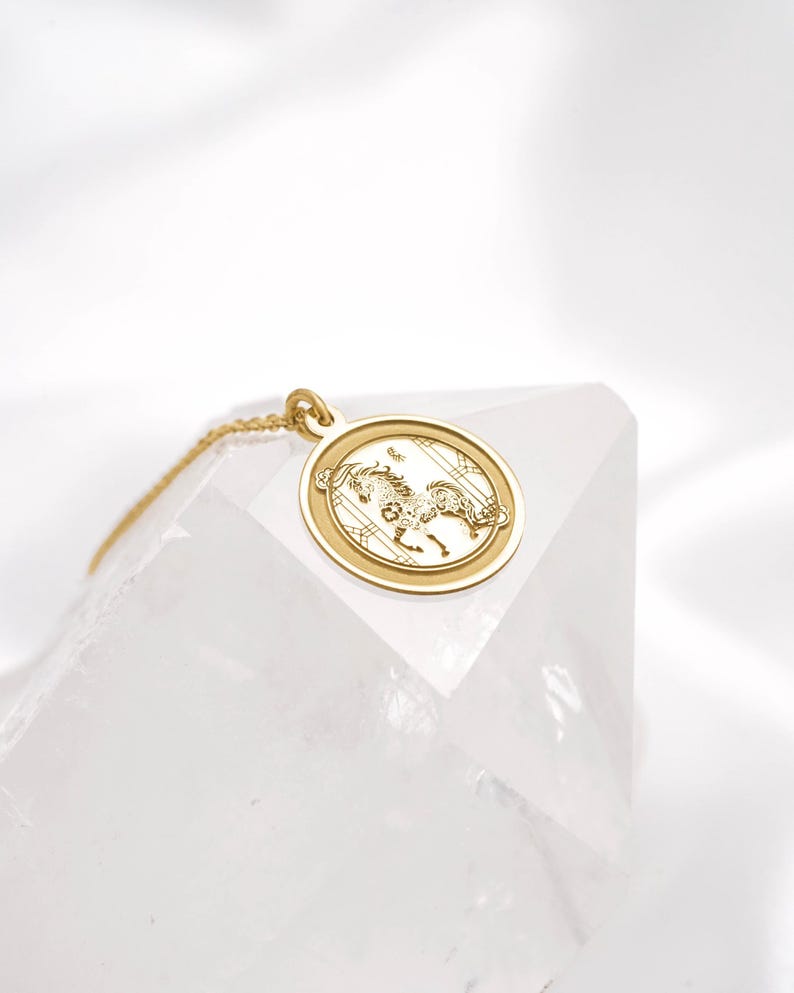 Minimalist 14k solid gold Year of the Horse pendant necklace photographed on clean white textile, highlighting the engraved horse design inside a smooth circular frame. A symbolic Chinese zodiac charm representing freedom and unstoppable drive, perfect for everyday layering. SEO terms: horse necklace, zodiac necklace, Chinese astrology jewelry, lunar new year gift, gold coin pendant, handmade medallion necklace.