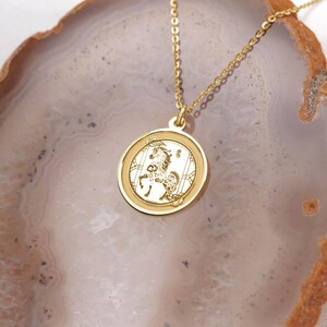 14k solid gold lunar new year horse necklace close-up showing a shiny round medallion pendant, raised border, and delicate cable chain. The Horse is linked to ambition, independence, and good fortune in Chinese zodiac traditions, making this a thoughtful birthday or New Year present. Handcrafted and finished by hand; offered with multiple pendant sizes and chain lengths. Search phrases: Chinese zodiac necklace, horse pendant, year of the horse jewelry.