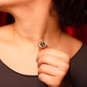 14k solid gold model wearing a delicate Year of the Horse pendant necklace, photographed to show real-life proportions and how the medallion sits with a fine chain. Symbolic of independence and momentum in Chinese zodiac tradition, it’s a thoughtful Lunar New Year gift and a personal astrology keepsake. Keywords: horse necklace, Chinese zodiac pendant, zodiac jewelry, minimalist gold charm, engraving necklace, handcrafted fine jewelry for daily wear.