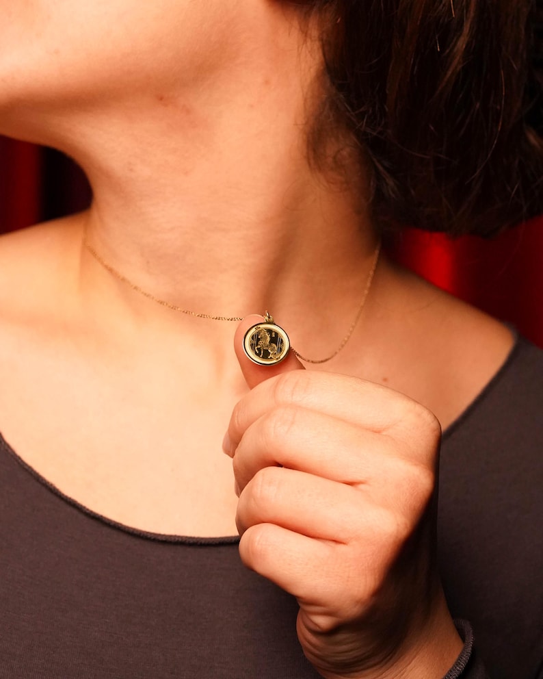 14k solid gold model wearing a delicate Year of the Horse pendant necklace, photographed to show real-life proportions and how the medallion sits with a fine chain. Symbolic of independence and momentum in Chinese zodiac tradition, it’s a thoughtful Lunar New Year gift and a personal astrology keepsake. Keywords: horse necklace, Chinese zodiac pendant, zodiac jewelry, minimalist gold charm, engraving necklace, handcrafted fine jewelry for daily wear.