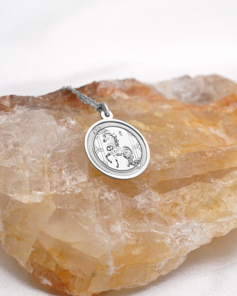 925 sterling silver option photo of the Year of the Horse coin pendant necklace, showing the same engraved horse motif and smooth circular frame in bright silver. Great for everyday wear, layering, and gifting for Lunar New Year or Chinese zodiac birthdays. Search terms: silver horse necklace, Chinese zodiac charm, year of the horse pendant, astrology jewelry. Handmade finish with clean details and a refined minimalist look.