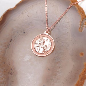 Close-up of a 14k rose gold Chinese zodiac horse medallion necklace, highlighting the soft blush metal color and detailed engraved Horse design. Inspired by Year of the Horse symbolism—confidence, vitality, and progress—this pendant is ideal for daily wear and gifting. Keywords: rose gold zodiac necklace, horse pendant, lunar new year gift, chinese new year jewelry, astrology necklace, handmade coin pendant with a smooth back for engraving.