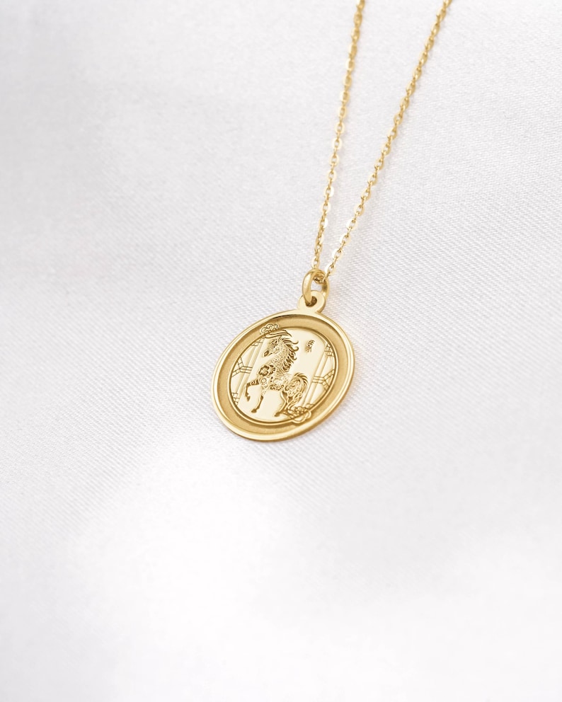 14k solid gold Horse zodiac necklace styled in a bright flatlay, showcasing the round coin pendant centered on a delicate chain. The Chinese zodiac Horse stands for freedom, ambition, and energetic new beginnings—perfect for Lunar New Year celebrations and meaningful gifting. Search phrases: year of the horse necklace, chinese new year jewelry, zodiac pendant, gold medallion necklace, minimalist charm, handmade engraving-ready piece.