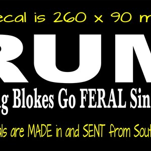May include: A black rectangular decal featuring the white text RUM and the phrase Making Blokes Go FERAL Since 1888. The yellow text at the top indicates the decal is 260 x 90 mm, and the yellow text at the bottom states these decals are MADE in and SENT from South Australia.