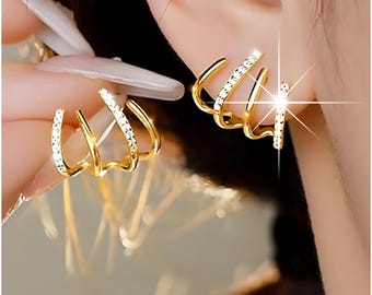 Brincos de garra: Conjunto de punho com zircônias cúbicas em ouro e prata