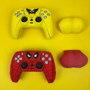 May include: Two PlayStation 5 DualSense controllers with custom skins. The top controller is yellow with a black Wolverine logo. The bottom controller is red with a black Spider-Man logo. Both controllers have matching yellow and red grip covers.