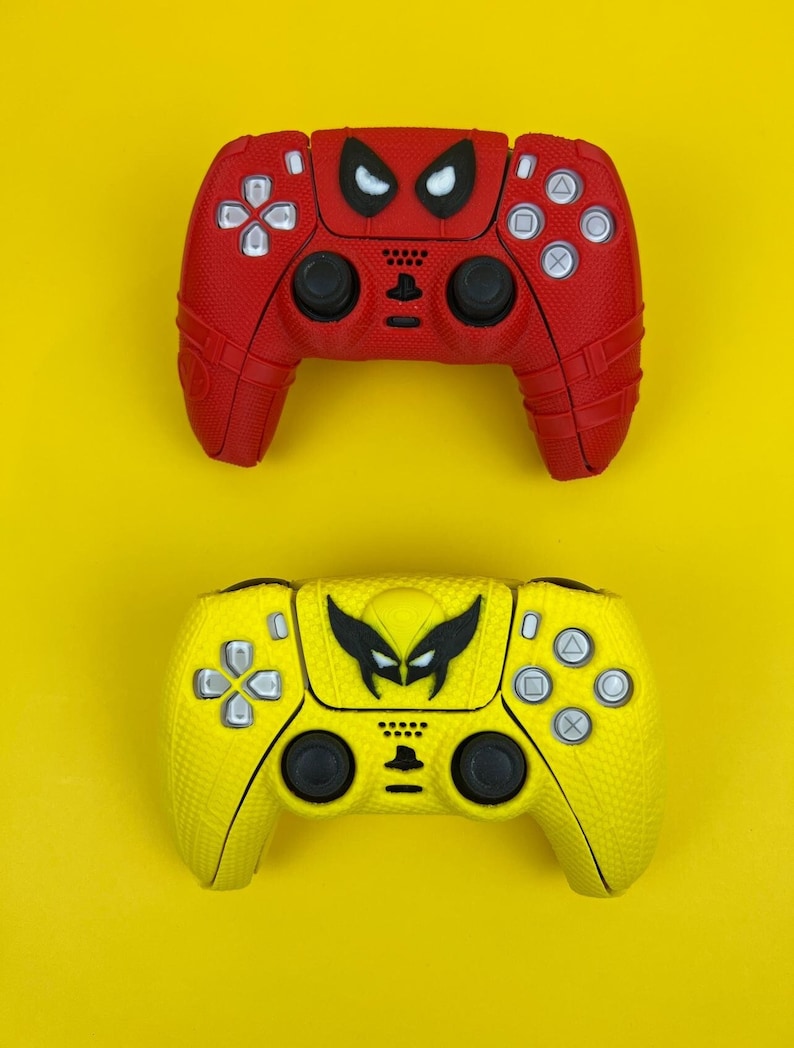 May include: Two video game controllers, one red with a black Spiderman design and one yellow with a black Wolverine design.