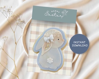 May include: Printable Easter cookie card and topper featuring a blue bunny with a white bow and floral wreath. The card has a gingham background and says "Happy Easter".