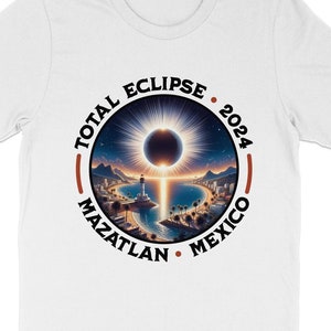 May include: White t-shirt with a black circle graphic that says "Total Eclipse 2024 Mazatlan Mexico". The graphic features a depiction of a solar eclipse.