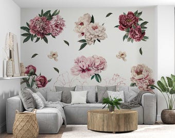 May include: A living room with a gray sectional sofa, a wooden coffee table, and a woven basket. The wall is decorated with large, watercolor-style peony flower decals in shades of pink and burgundy, with green leaves.