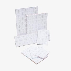 May include: An assortment of Post-it note pads in various sizes. The pads are white with a repeating pattern of the Post-it logo. The pads are arranged in a layered composition, showcasing the different sizes available for office or home use.