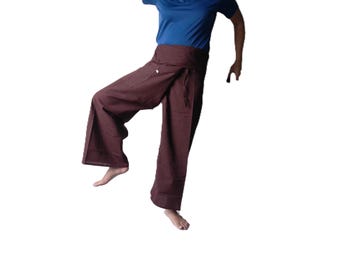 May include: Dark brown wrap-style trousers featuring a wide-leg silhouette and a fold-over waistband with a tie closure. The pants are constructed from a solid-colored fabric and include a side pocket detail on the right leg for utility.
