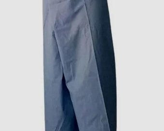 May include: A solid slate blue wrap skirt featuring a wide, folded waistband with integrated fabric ties. The garment has a straight, floor-length silhouette with a prominent overlapping front panel that creates a clean, vertical line down the center.