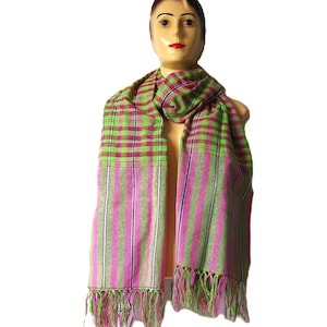 May include: A pink and green striped scarf with fringe on the ends. The scarf is made of a soft, woven fabric.