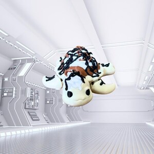 May include: A whimsical turtle-shaped dessert with a light-colored body, cream-colored head and feet, and a shell topped with brown, white, and black icing. The dessert is set against a futuristic, white background.