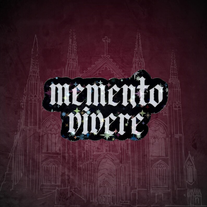 May include: A dark red background with a white sketch of a cathedral. A black sticker with the words "memento vivere" in white gothic font is overlaid on the image. The sticker has colorful star accents.