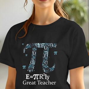 May include: Black t-shirt featuring a large Pi symbol filled with mathematical symbols and Greek letters. Below the Pi symbol, the text reads "E=πR²ly Great Teacher". The design is in shades of blue and white.