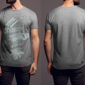 May include: Gray t-shirt featuring a detailed schematic of an engine. The front of the shirt displays the engine diagram in a light blue color, with the word "REDEFINED" visible. The back of the shirt is plain gray with the letters "LVLA" printed at the bottom.