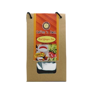 May include: A brown paper pouch with black string handles containing Red Ginger Tea. The label features the text Coffee 'n Soul, Red Ginger Tea, Gift from Bali, and Sugar Free, along with an image of a white teacup and fresh ginger roots.