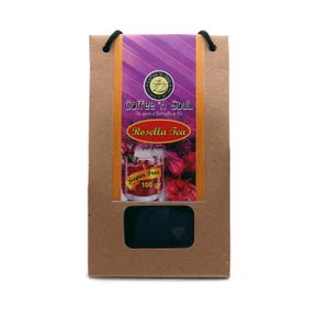 Könnte beinhalten: Eine braune Papiertüte mit schwarzen Kordelgriffen, die Rosella-Tee enthält. Das Etikett zeigt den Text Coffee 'n Soul, The Spirit of Bali Coffee & Tea, Rosella Tea, Sugar Free und 100 gr sowie ein Bild eines Glases mit rotem Tee.