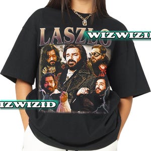 May include: Black t-shirt with a graphic print of a group of people with the text "Laszlo" on the front.