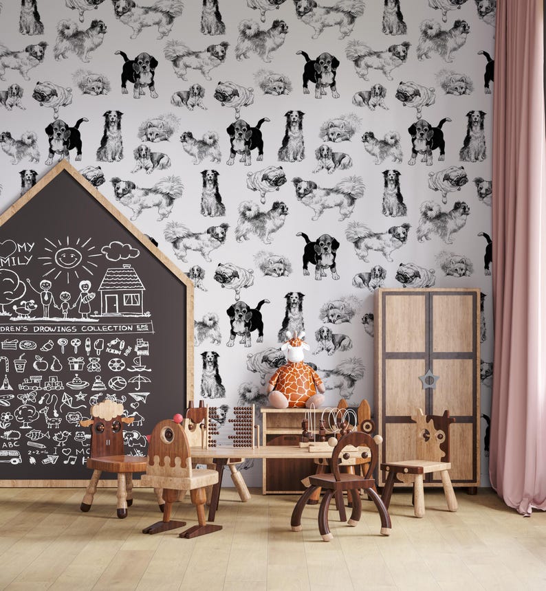 May include: A white wall with a black and white dog pattern wallpaper. The wall is decorated with a chalkboard with a drawing of a family and a house. There are wooden children's chairs and a table with a giraffe toy on it.