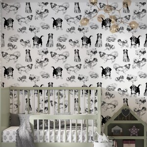 May include: Black and white illustration of various dog breeds in a repeating pattern on a white background. The wallpaper is in a nursery with a crib and a toy house.