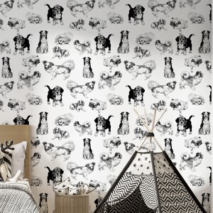 May include: Black and white wallpaper featuring a repeating pattern of dogs in various poses. The wallpaper is shown in a room with a teepee tent and a wicker basket.