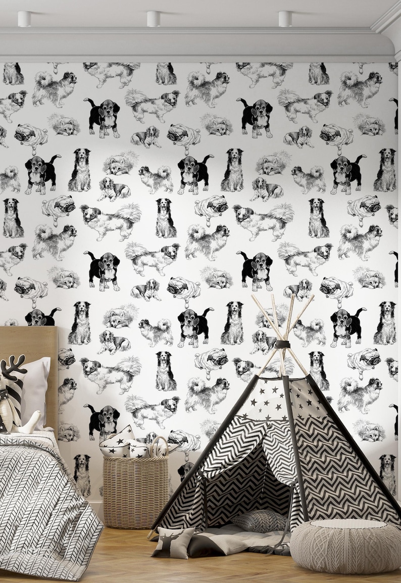 May include: Black and white wallpaper featuring a repeating pattern of dogs in various poses. The wallpaper is shown in a room with a teepee tent and a wicker basket.