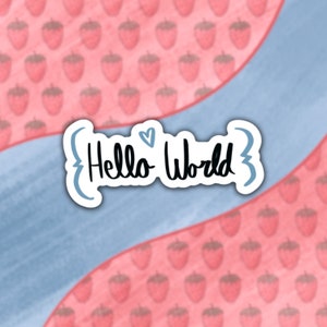 May include: A blue and white sticker with the text "{Hello World}" on a pink background with a pattern of pink strawberries.