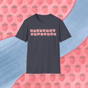 May include: A navy blue t-shirt with the words "SOFTWARE ENGINEER" spelled out using pink keyboard keys.