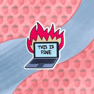 May include: A laptop computer on fire with the text "This is fine" on the screen. The laptop is on a white background with a pink and white strawberry pattern.