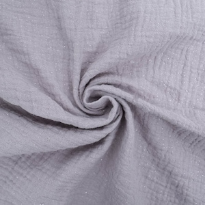 May include: A close-up of a soft, grey fabric with a subtle sparkle. The fabric is textured and has a crinkled appearance.