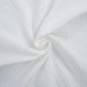 May include: White fabric with a subtle sparkle, ideal for crafting or sewing projects.