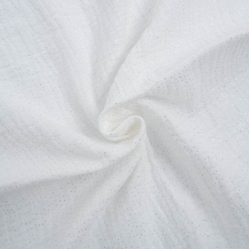 May include: White fabric with a subtle sparkle, ideal for crafting or sewing projects.