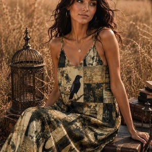 May include: A sleeveless maxi dress featuring a patchwork-style print in muted earth tones of brown, olive, and cream. The pattern includes illustrations of a black raven, vintage birdcages, butterflies, and script text throughout the fabric.