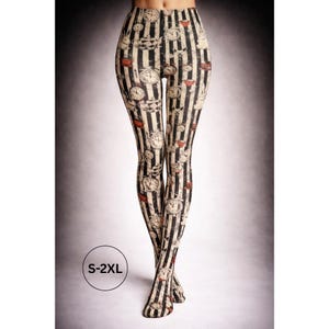 May include: Black and white striped leggings with a repeating pattern of clocks and teacups. The leggings are a high-waisted style and feature the size range S-2XL.