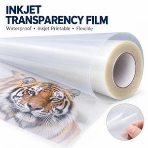 May include: A roll of clear inkjet transparency film featuring the text INKJET TRANSPARENCY FILM Waterproof • Inkjet Printable • Flexible. The film displays a printed image of a tiger's face, and a small circular inset shows a hand holding the film.