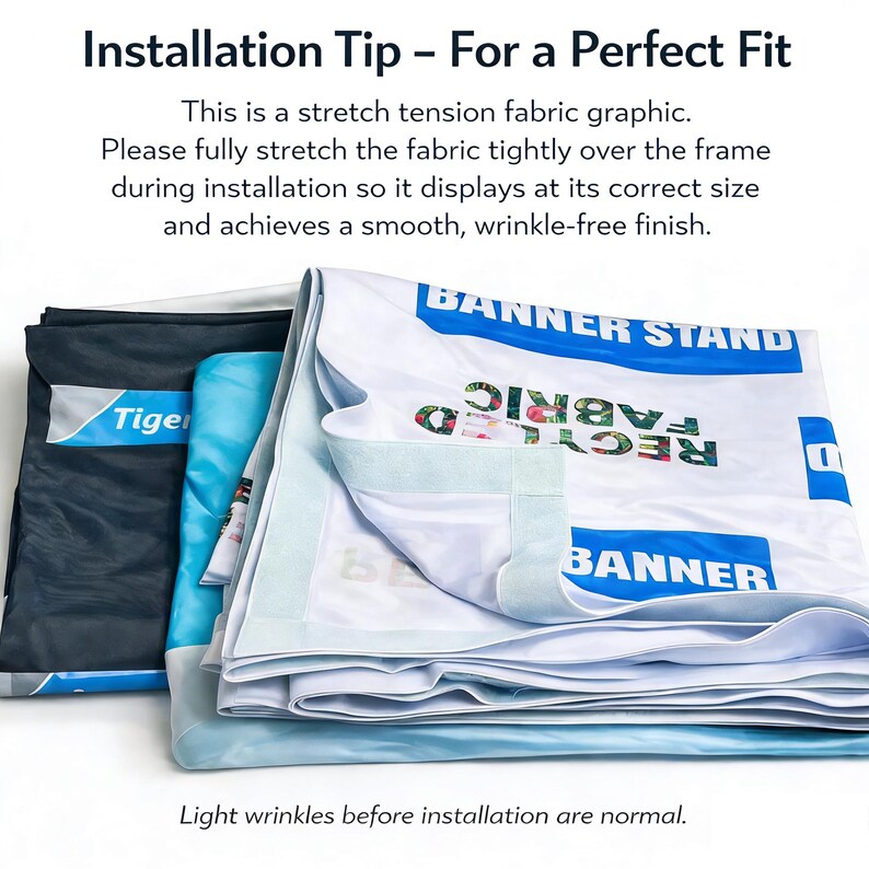 May include: A stack of folded banner stand fabric graphics. The top banner is white with blue text that reads "BANNER STAND" and "BANNER". The text "RECYCLED FABRIC" is also visible. The image includes text that says "Installation Tip - For a Perfect Fit".