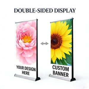 May include: Double-sided display banner with a pink flower and a sunflower. The banner reads "YOUR DESIGN HERE" and "CUSTOM BANNER". The display is silver and black.