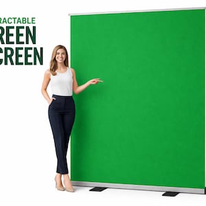May include: A retractable green screen with the text "RETRACTABLE GREEN SCREEN" in dark green. A woman in a white tank top and navy blue pants stands next to the screen, pointing at it. The screen is mounted on a silver frame.