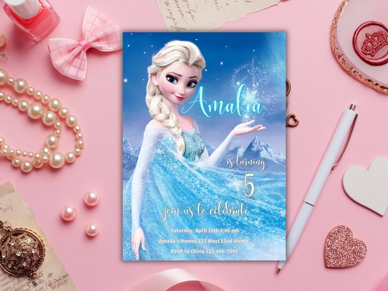 May include: A blue and white Frozen-themed birthday invitation with a picture of Elsa. The invitation says "Amalia is turning 5, join us to celebrate" and includes the date, time, location, and RSVP information.
